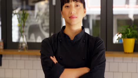 beautiful waitress standing with arms crossed in cafe 4k