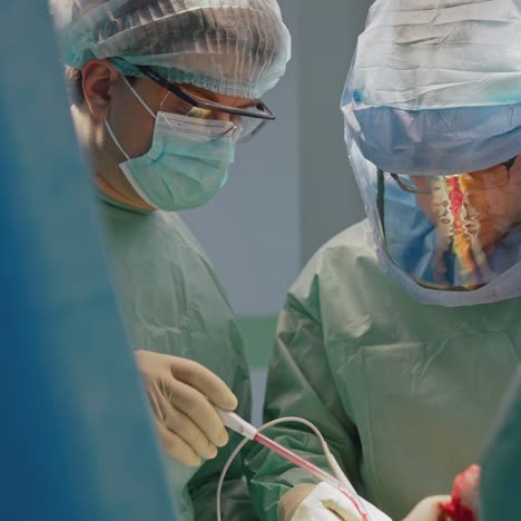 surgical procedure by doctors. surgeons in safety medical suits perform an operation in clinic. surgery during virus crisis. health care concept