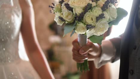 the groom gives the bride a bouquet