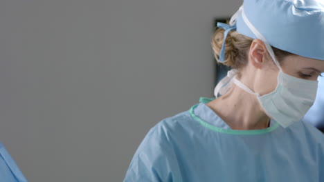 caucasian female surgeon operating on patient in operating theatre, slow motion