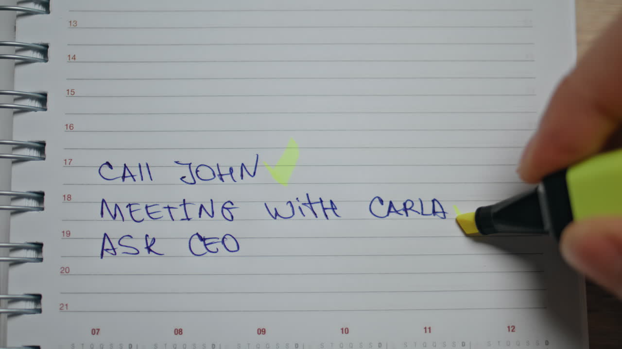 Office worker putting marks in schedule at table closeup. Man marking tasks