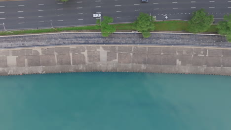 top down aerial footage panning across the lakefront trail in downtown chicago with a group of runners exercising