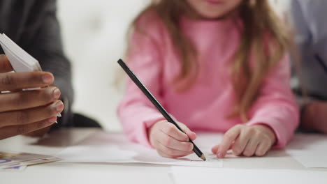 Junior blonde schoolgirl learns English with black teacher