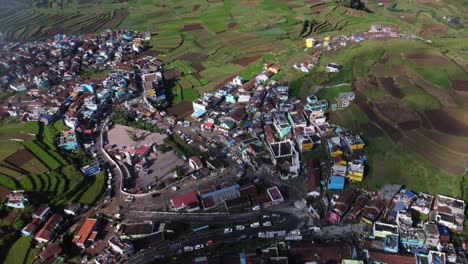 Drone-shot-of-historical-Kuzhanthai-Velapar-Temple-in-Poombarai-village-on-Palani-hills,-Terrace-farming-landscape-in-the-mountains-of-Poombarai,-Tamil-Nadu,-India