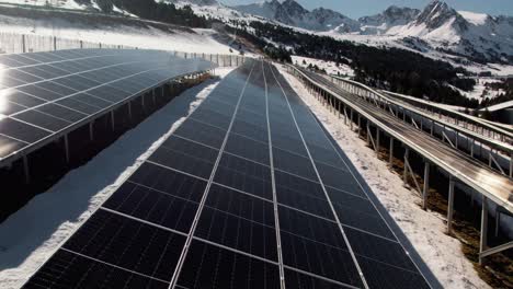 solar panels close up aerial, winter mountain landscape tilt up revealing