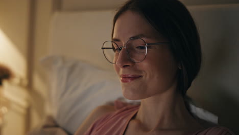 smiling woman resting home on weekend night closeup. relaxed girl chill browsing