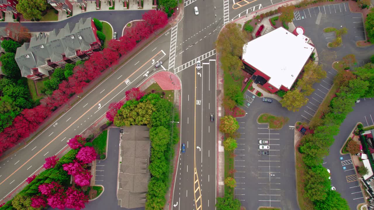 Bird's-eye view of an intersection in the Atlanta, Georgia suburbs with vivid autumn trees
