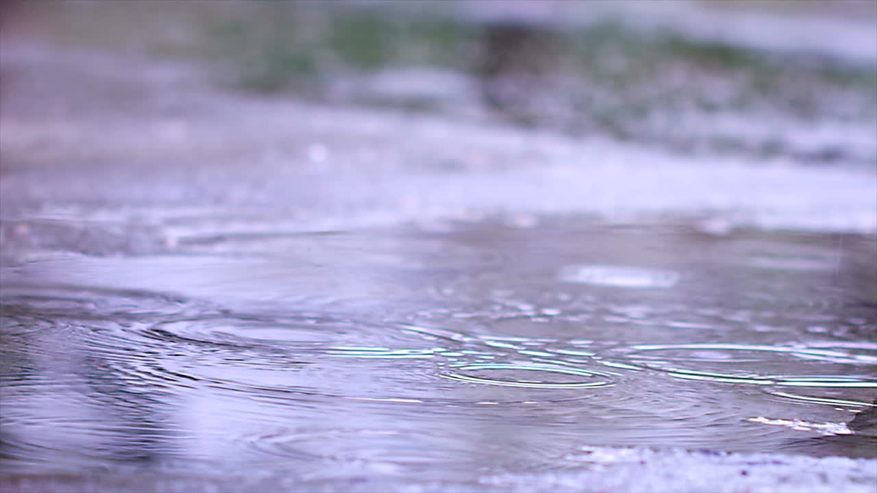 Rain Drops Falling To Asphalt