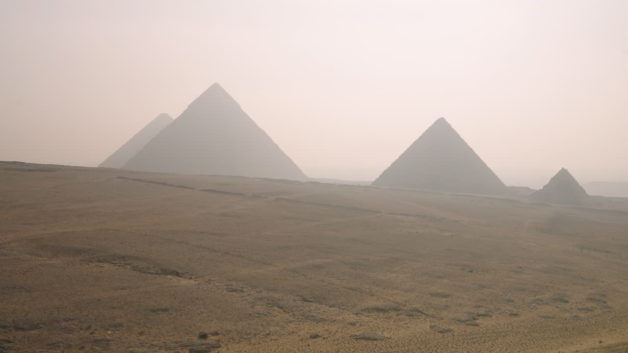 Man With a View of the Pyramids at Sunrise in Giza, Egypt - Panning Shot