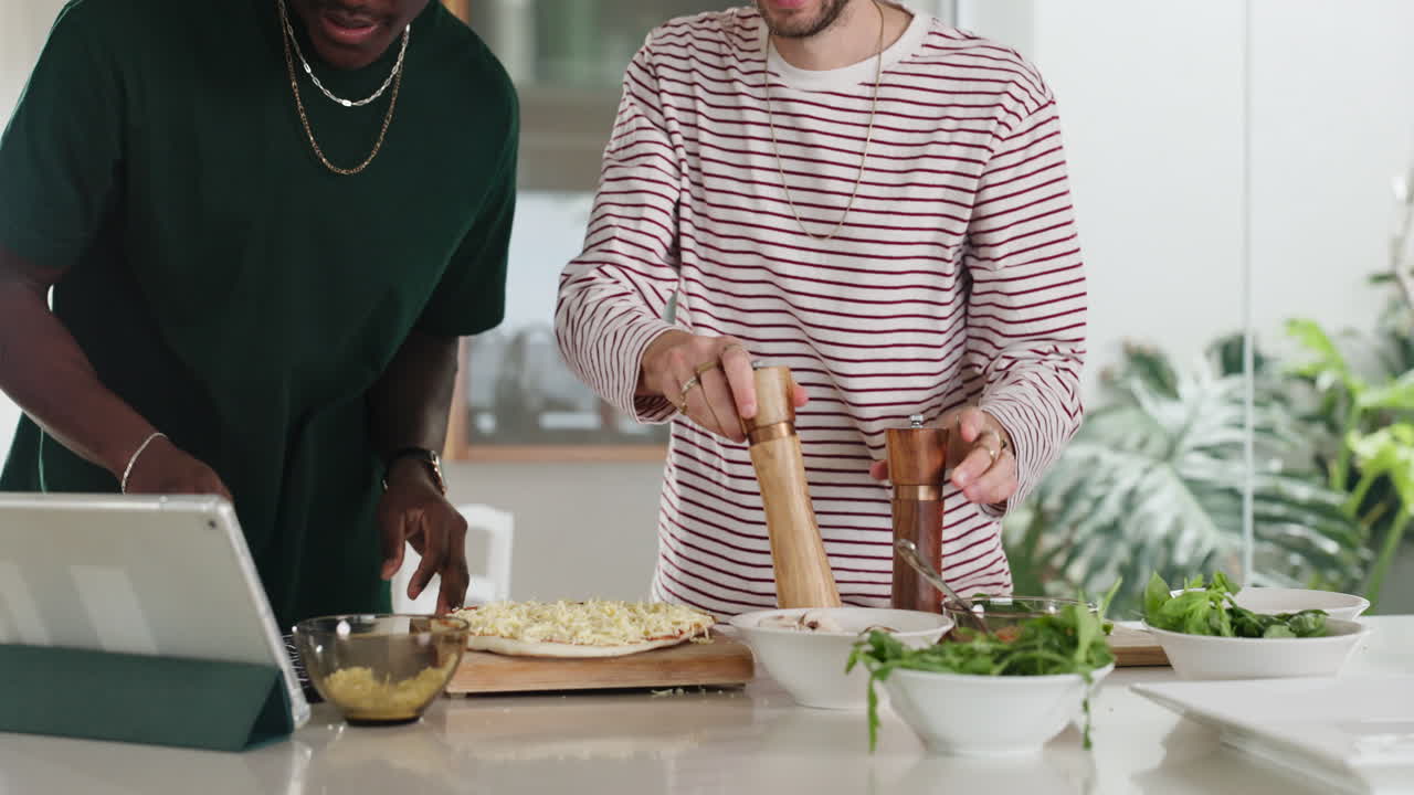People cooking pizza in the kitchen