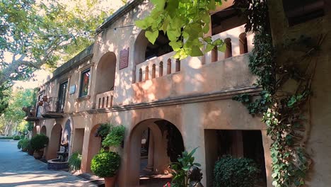 Pan-from-a-balcony-to-the-cobblestone-alleyway-between-buildings-at-the-Tlaquepaque,-Sedona