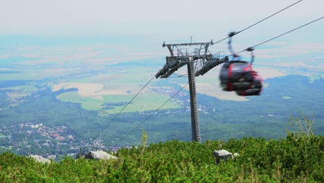 gondola cable cars rush up and down the green summer slopes of high tatra mountains, slovakia, time lapse