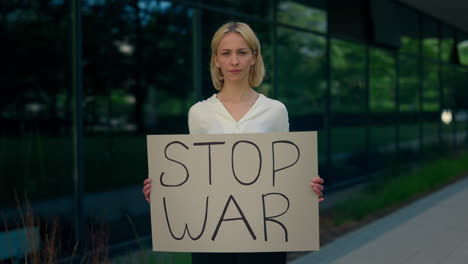 woman holding "stop war" sign