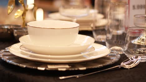 elegant table setting with white dinnerware and glassware