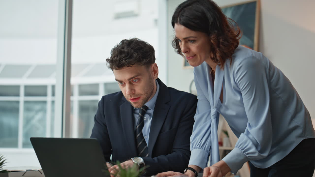 Serious businesspeople discussing report in office closeup. Man displeased work