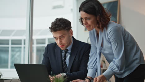 serious businesspeople discussing report in office closeup. man displeased work