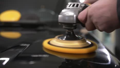 car polish with a yellow grinding machine close up in 50fps, slow motion ready