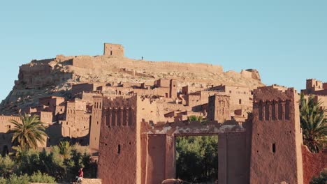 close view of traditional mud buildings and palm trees in ait ben haddou, morocco