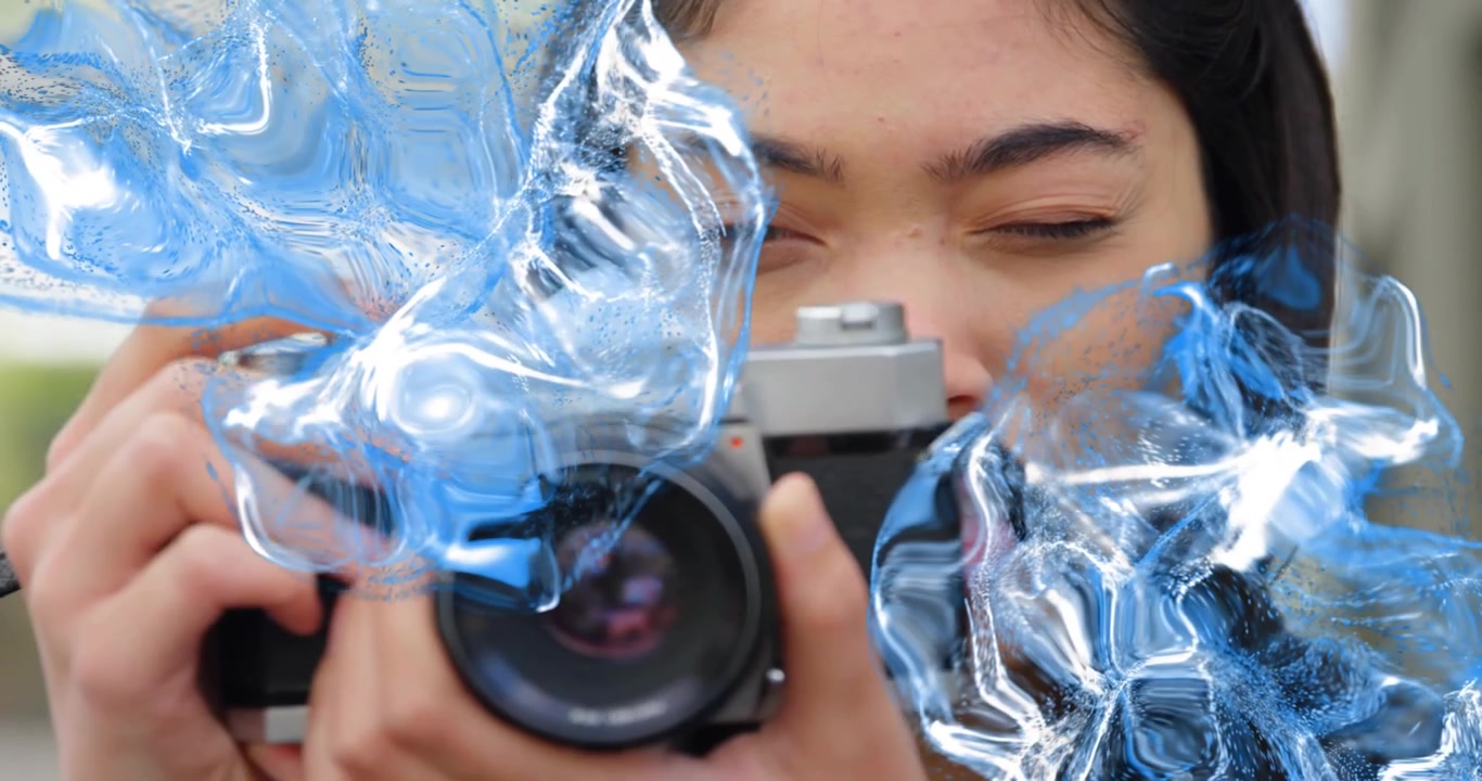 Fotógrafa levantando a câmera enquanto distorções azuis giram ao redor do rosto para fotografia