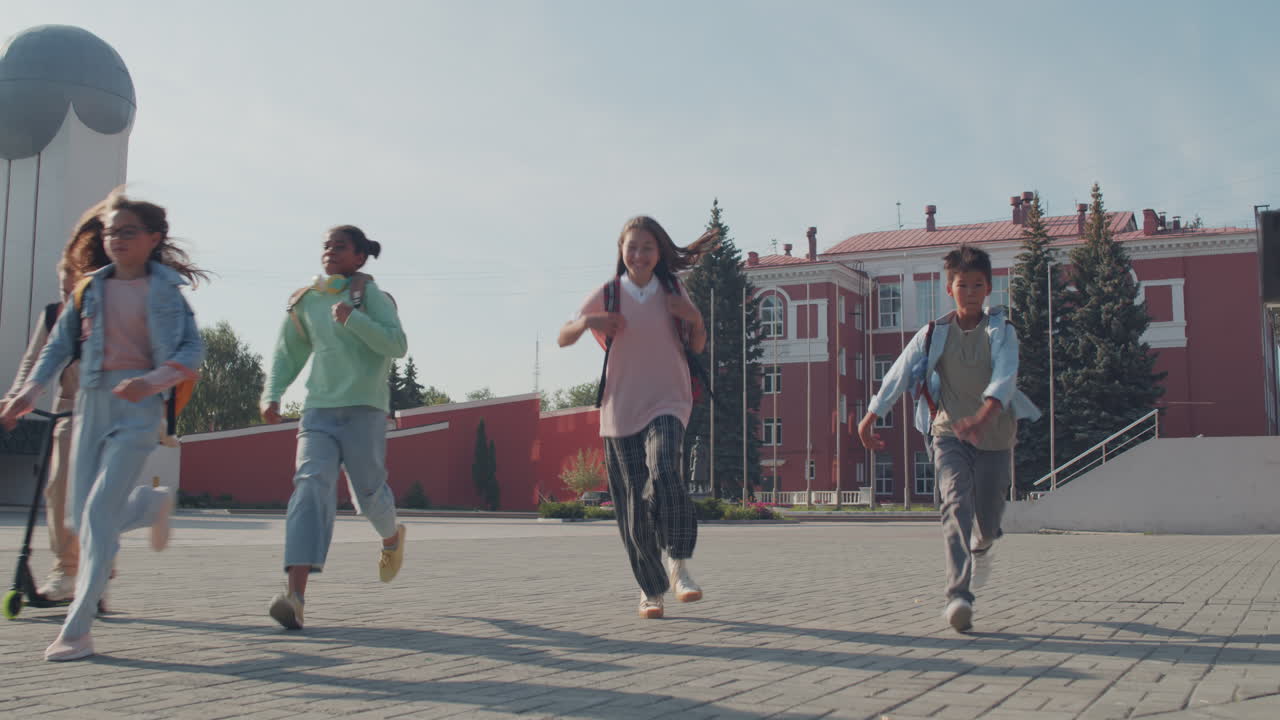Group of Happy Schoolchildren Running