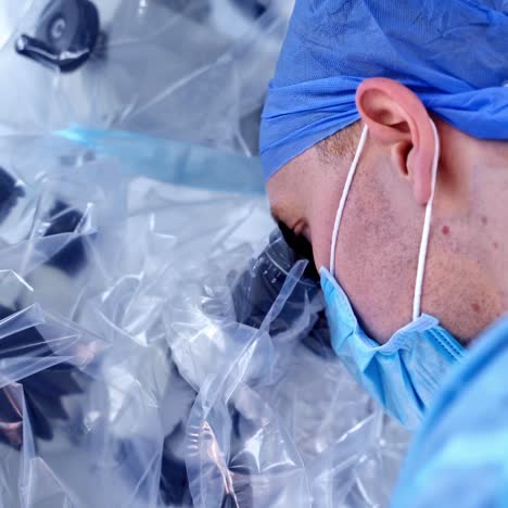 surgeon using operating microscope