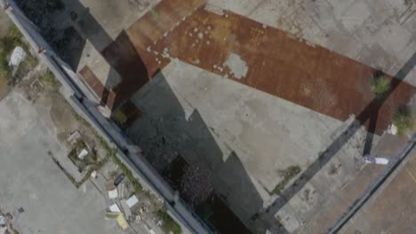 Drone-captures-top-down-view-of-a-destroyed-old-factory-in-a-war-torn-scenario