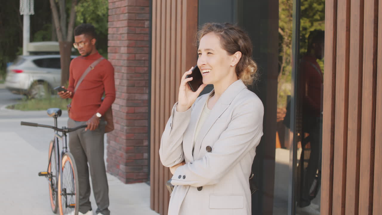 Business Woman Making Phone Call Outside Office