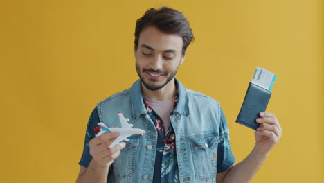 man holding airplane and passport