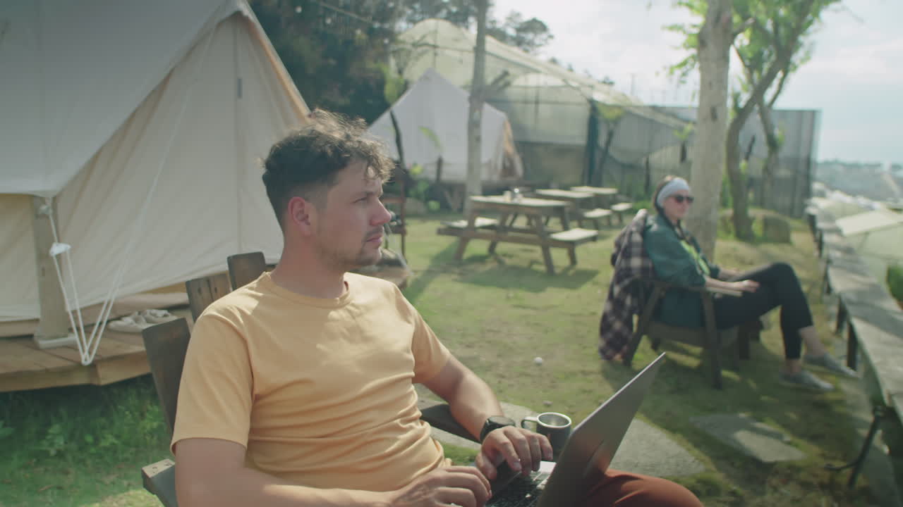 Man Resting at Glamping and Using Laptop