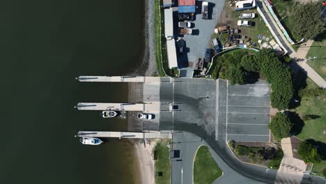 A-car-and-trailer-driving-away-from-a-boat-ramp-after-launching-a-vessel-in-the-water