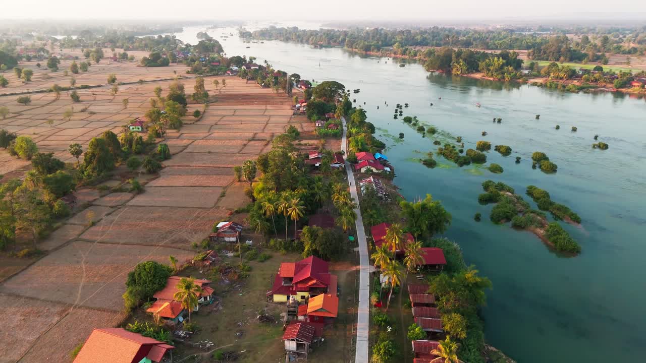 Aerial fly traditional rural village in Four Thousand Islands, Laos, Asian village, agricultural fields