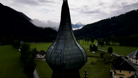 slovenia small town surrounded by misty pine forest mountains aerial drone 10