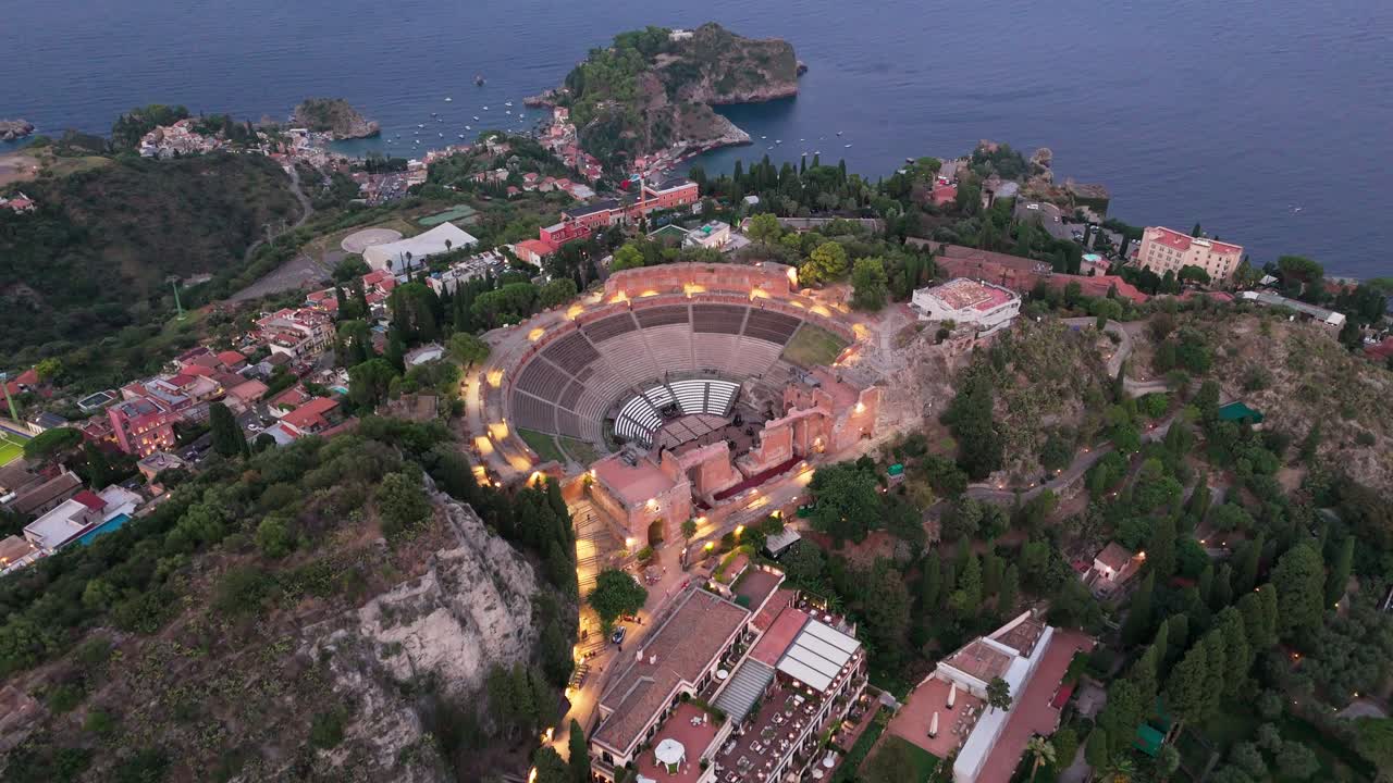 Drone push shot from above the amphitheatre, revealing detailed interior architecture and historic stone structures up close
