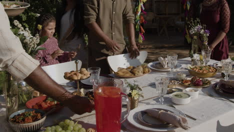 family and friends enjoying an outdoor festive meal