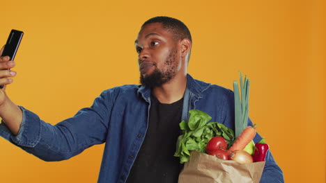 Vegan person talking on videocall conference while shopping for groceries