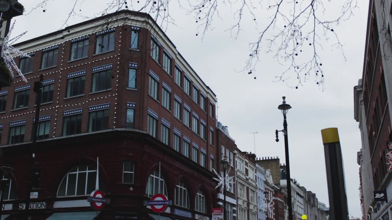 Underground station in London UK. The great London train house. An entrance to the underground train station. A clean shot of the London street in the Christmas season with yellow street light and man