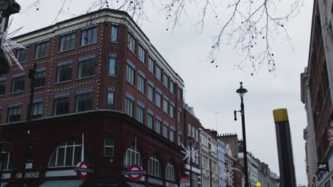 underground station in london uk. the great london train house. an entrance to the underground train station. a clean shot of the london street in the christmas season with yellow street light and man