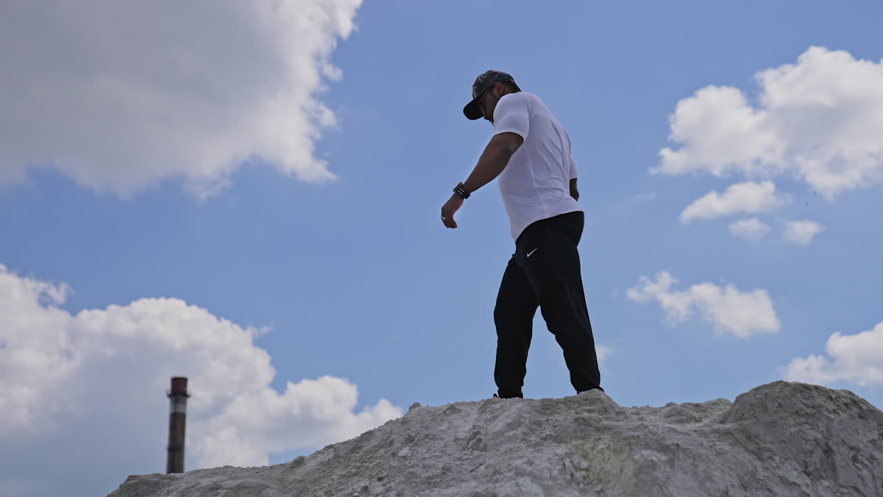 Young man posing outdoor. View of strong african man posing outdoor