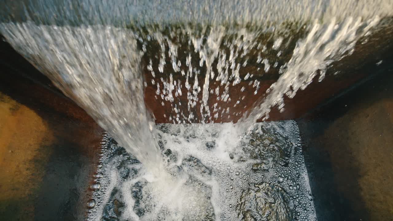 Water flowing from a treatment plant, symbolizing cleanliness, sustainability, and environmental care, with a focus on water purification and eco-friendly practices.