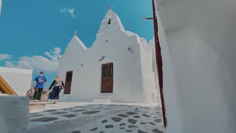 reveal of island church in mykonos at the end of an iconic alley