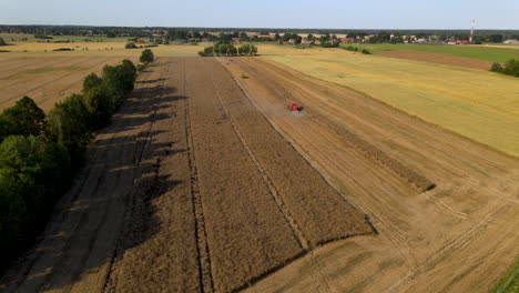 dramatic farming landscape near mlynary poland as combine harvesters work the land