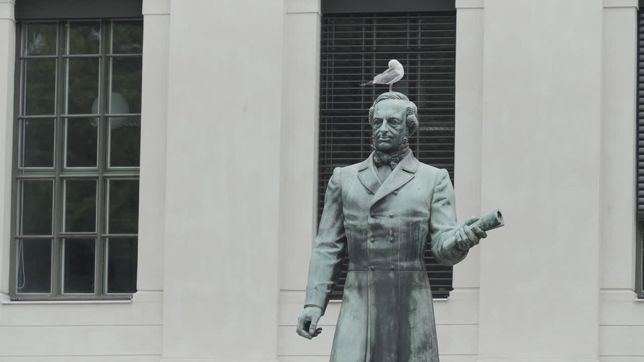 Statue of a Man with a Seagull on His Head