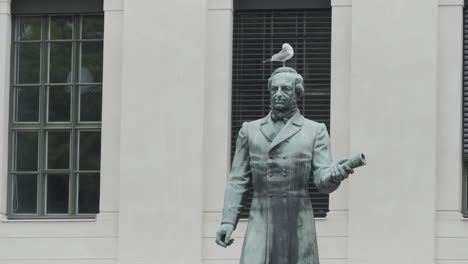 statue of a man with a seagull on his head