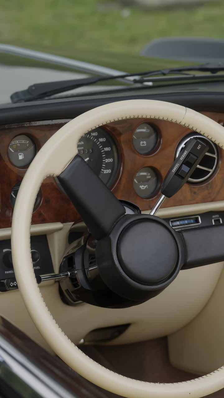 Interior view of a classic luxury car showing the steering wheel and dashboard
