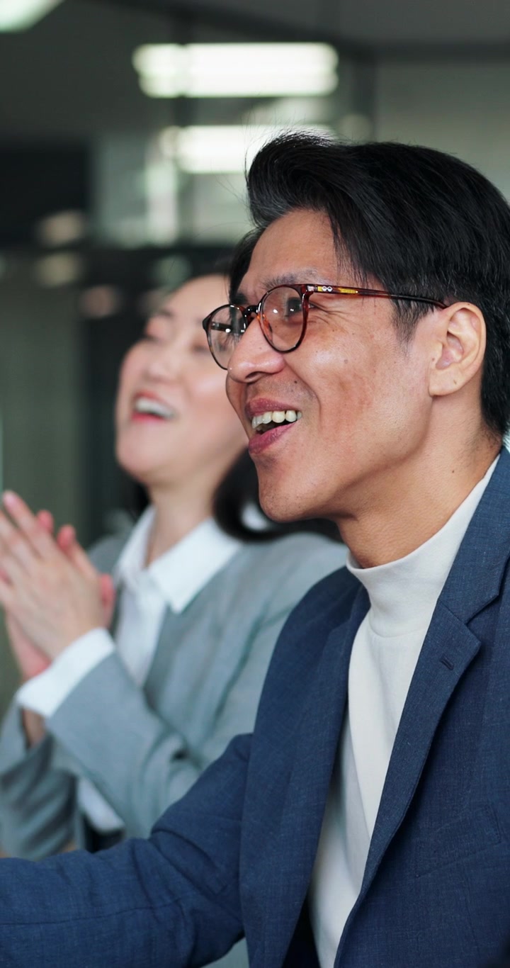 Business Professionals Applauding During a Meeting in an Office