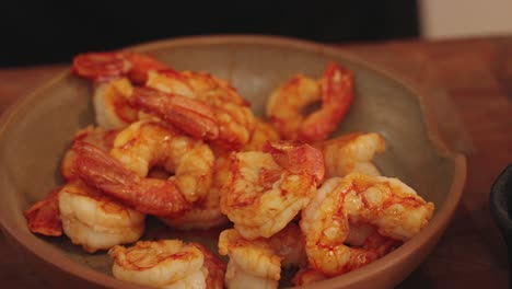 a bowl of delicious, moist and juicy peeled prawns in slow motion, close up shot of home meal food preparation