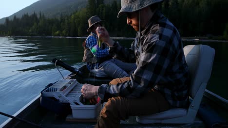 two fisherman preparing for fishing in the boat 4k