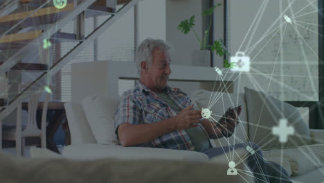 animation of network of connections over senior caucasian man using tablet