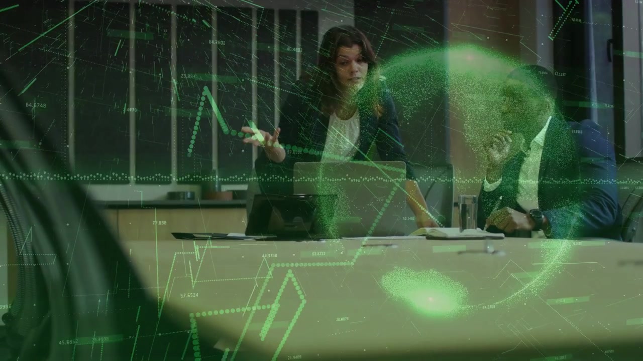Business team leaning over laptop and pointing, causing green overlay over table while man thinking