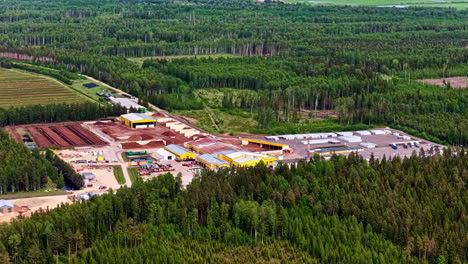 peat factory complex with surrounding storage yards and forest landscape seen from above
